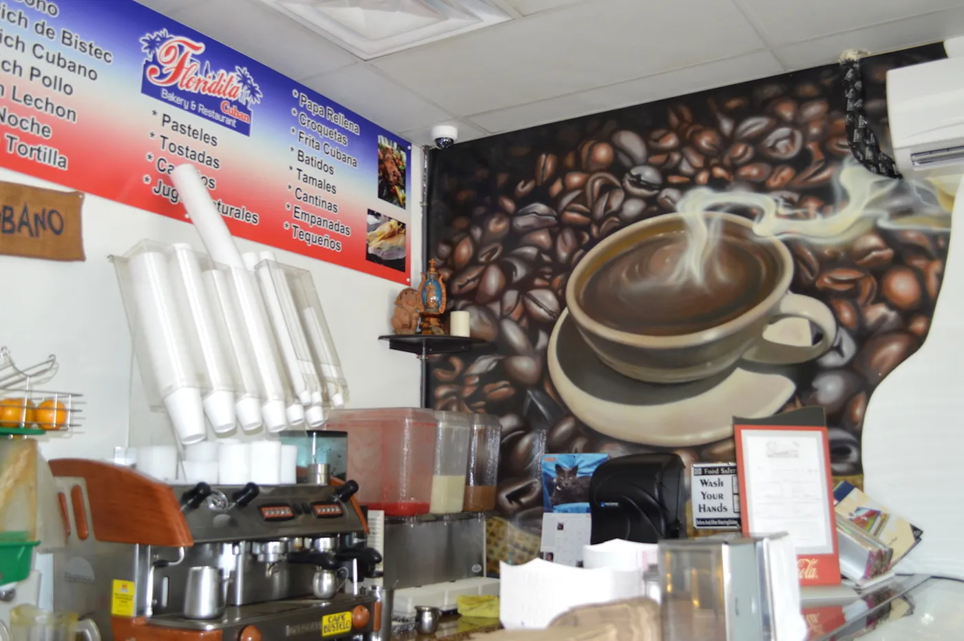 The coffee station with a painted coffee mural behind it