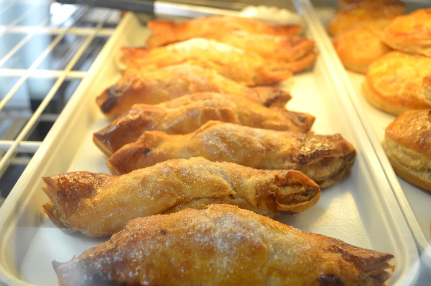 Golden empanadas lined up in the Floridita bakery case