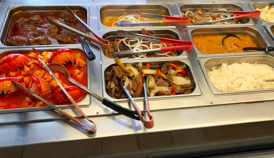 The hot bar with trays of Cuban dishes